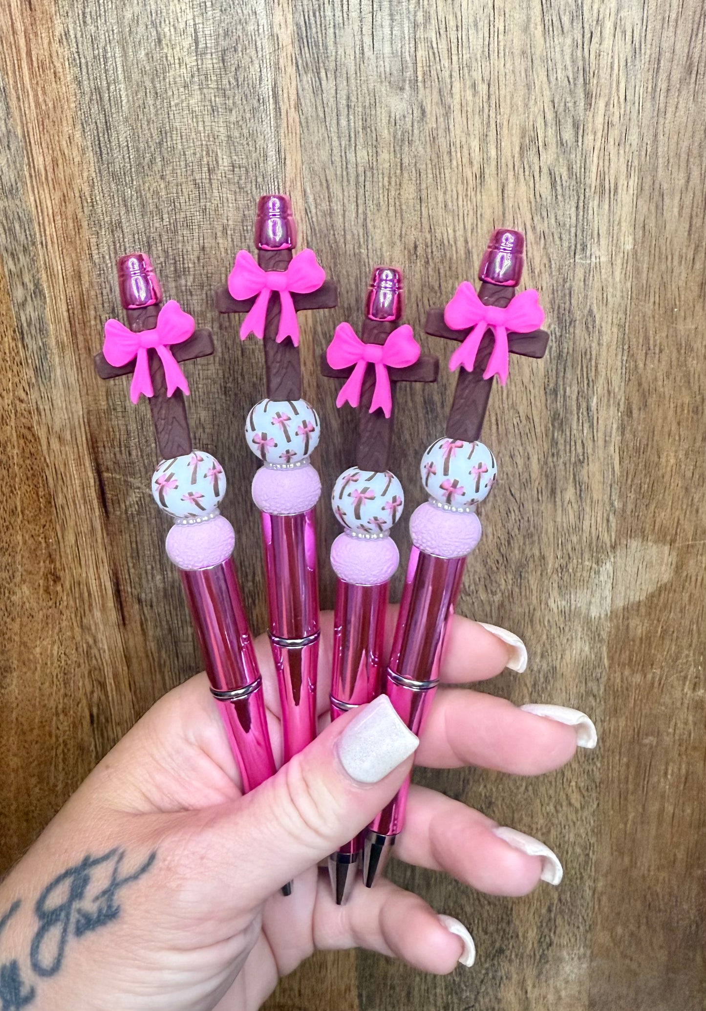 Pink bow on the cross pen