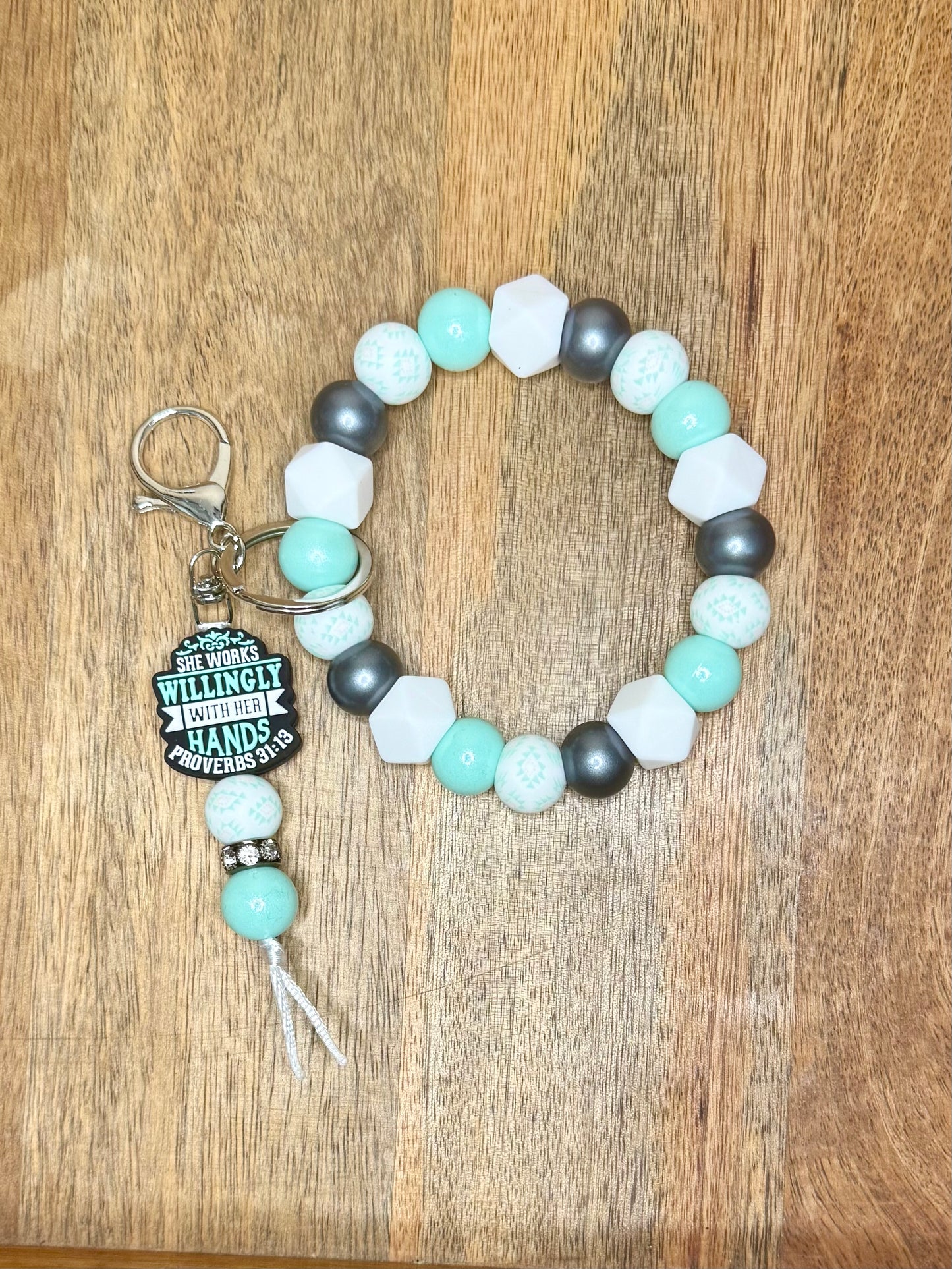 She works willingly with her hands wristlet w/dangle keychain