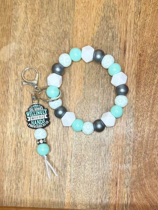 She works willingly with her hands wristlet w/dangle keychain